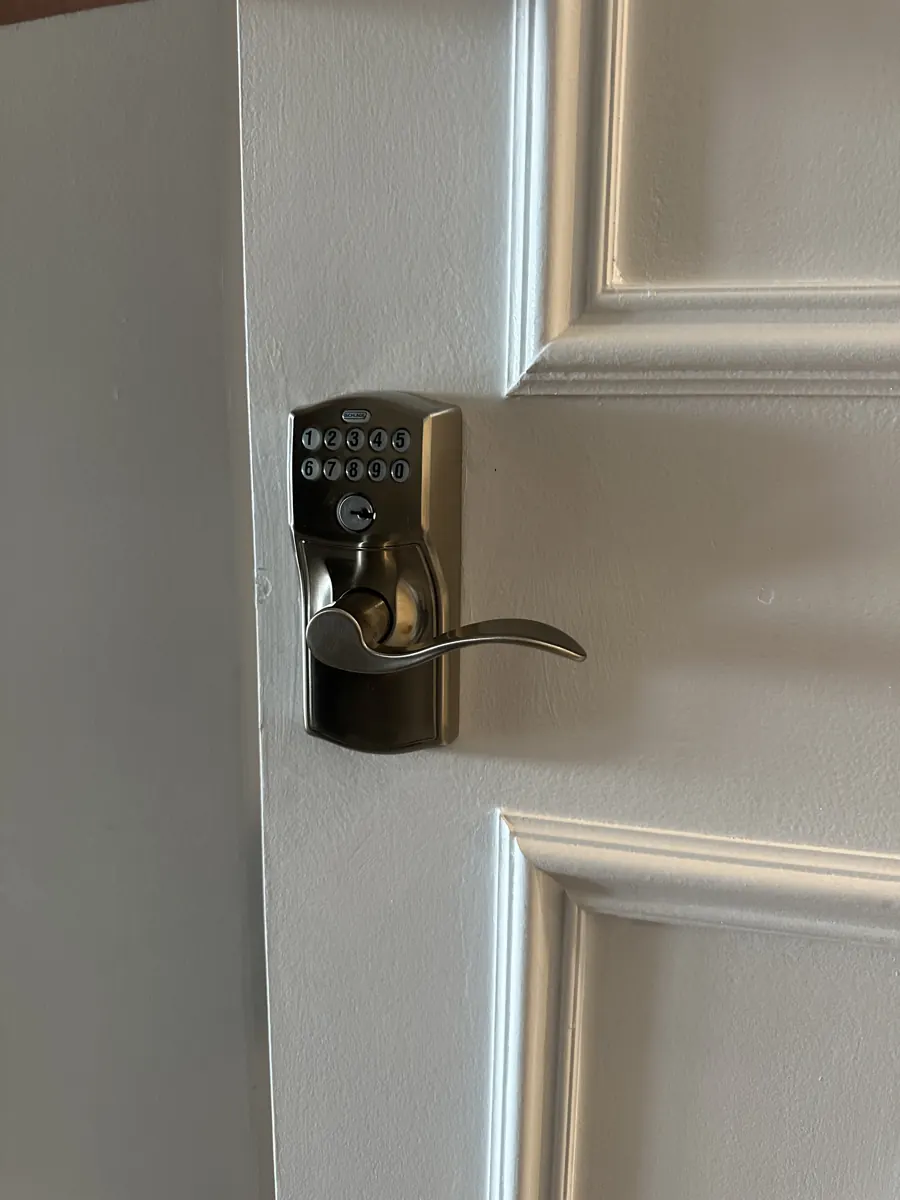 Keypad lever lock with key override on a white paneled door